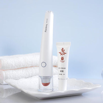 Aiyisheng Heated Bian Stone Eyes Massage Device and eye cream on a tray